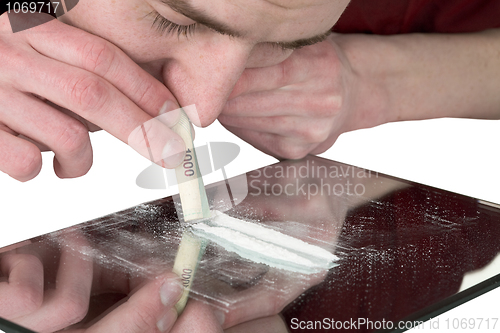 Image of Guy smelling drug