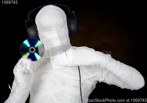 Image of DJ costume mummy with ear-phones and disc