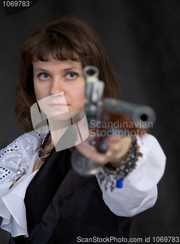 Image of The girl - pirate with ancient pistol in hand