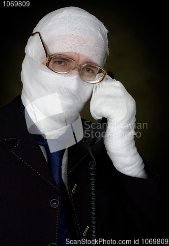 Image of Man in bandage calling on phone