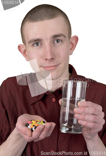 Image of Boy with tablets and glass of water