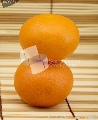 Image of Two ripe mandarins on mat