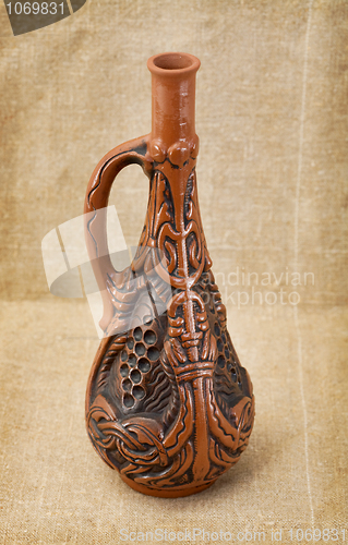 Image of Ceramic bottle on textile background