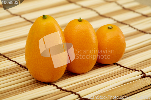 Image of Fresh kumquat against a mat