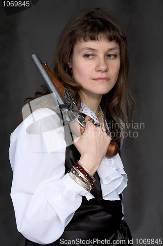 Image of Girl - pirate with ancient pistol in hand