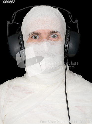 Image of Man in bandage with ear-phones 