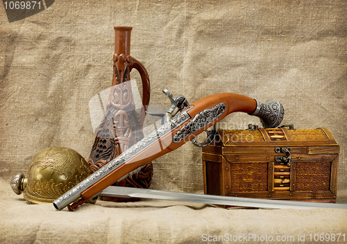 Image of Pistol, bottle, rapier and trunk