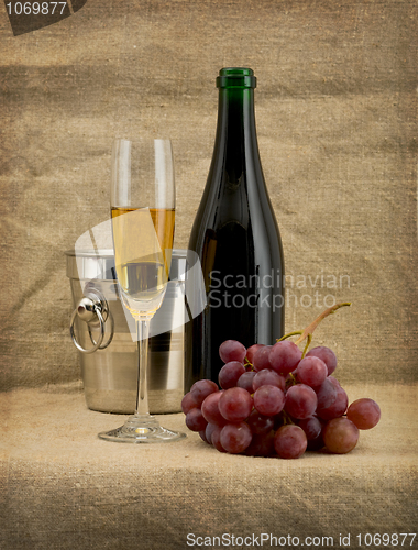 Image of Glass of wine and a champagne bottle