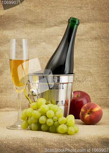 Image of Still life with champagne bottle, goblet and fruits