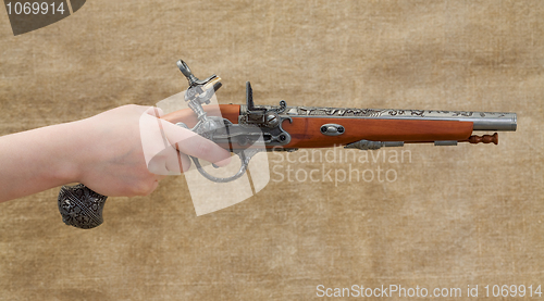 Image of Ancient pistol in female hand