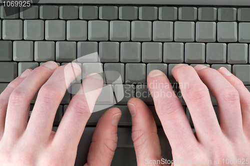 Image of Male fingers on keyboard