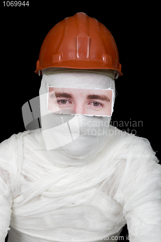 Image of Bandaged man in helmet with false paper eyes