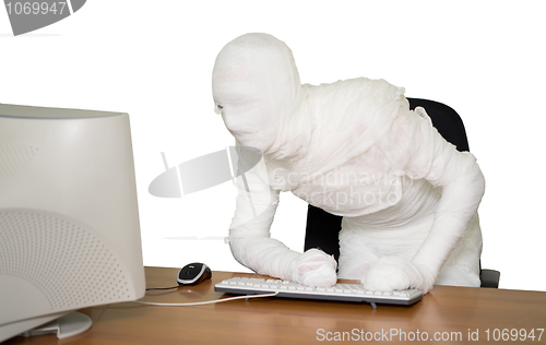 Image of Bandaged businessman on workplace in office