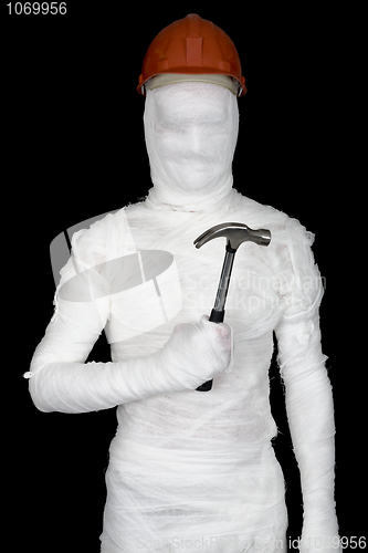 Image of Laborer in bandages with helmet and hammer