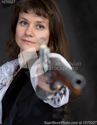 Image of The girl - pirate with ancient pistol in hand