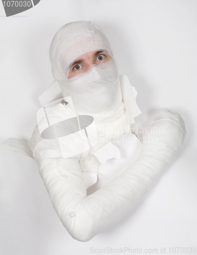 Image of Boy in bandage put out from hole in paper