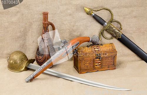 Image of Bottle, rapier, sword, pistol and chest