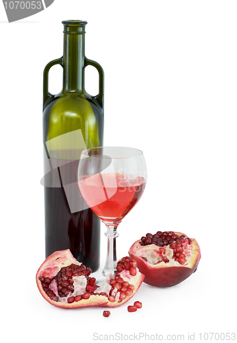Image of Glass of wine, bottle and a red pomegranate