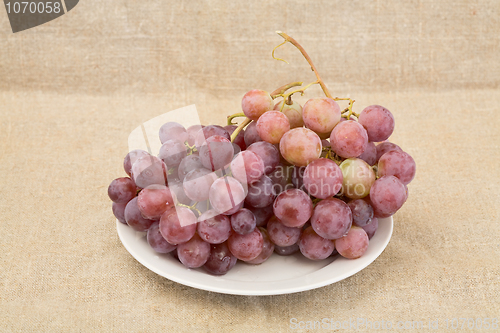 Image of Grape on plate on textile background