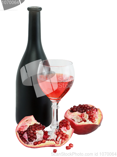 Image of Glass of wine, bottle and a red pomegranate