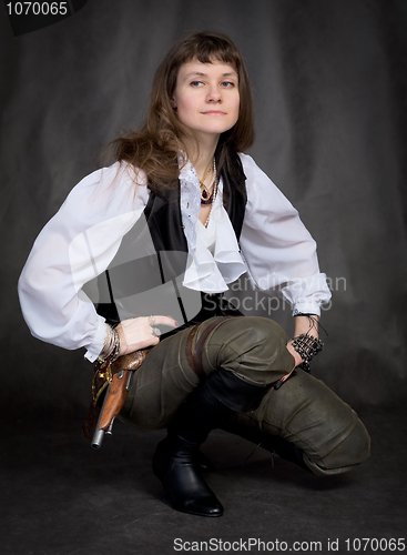 Image of Girl - pirate with pistol sit on black