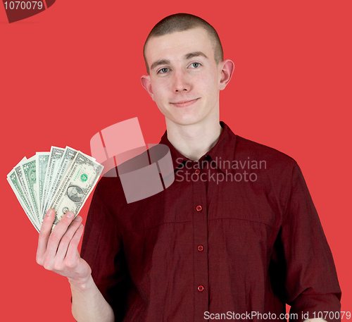 Image of Young man with pack of dollars