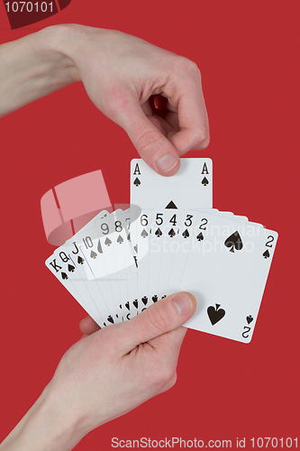 Image of Playing cards on hands