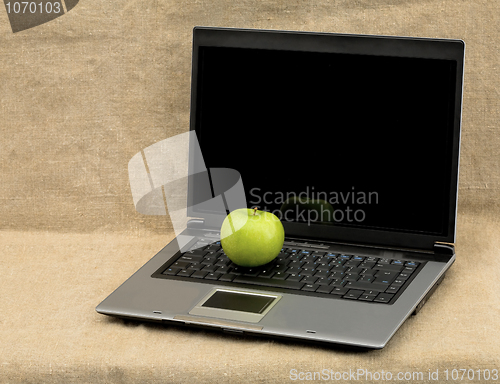 Image of Laptop and green apple