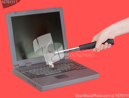 Image of The laptop and hammer