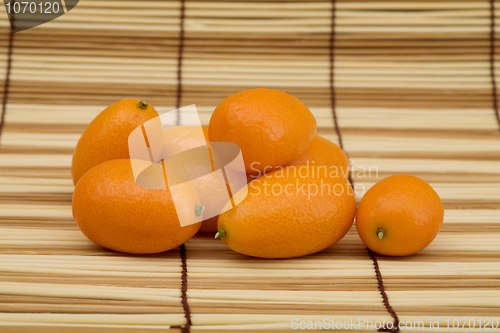 Image of Fresh kumquat against a mat