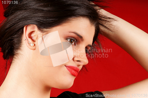 Image of Young woman playing with hair