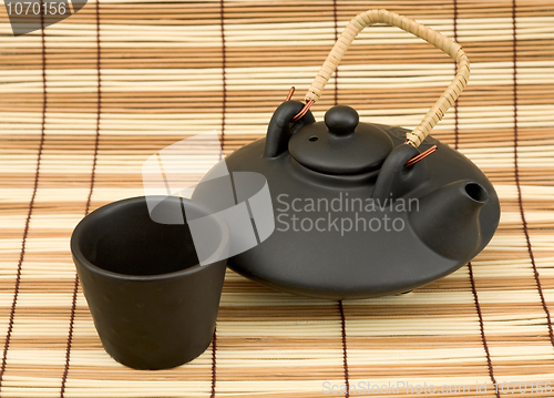 Image of Black ceramic chinese teapot and mugs