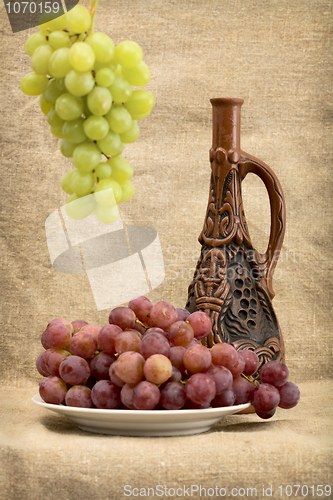 Image of Grapes and wine in bottle