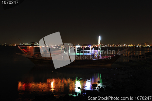 Image of Dhow at night and reflection