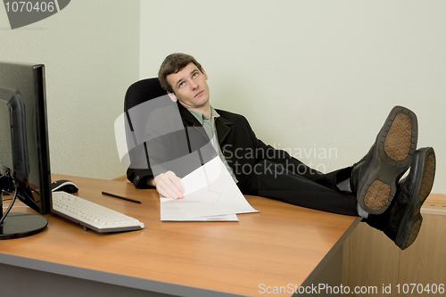 Image of Boss in black suit on a workplace
