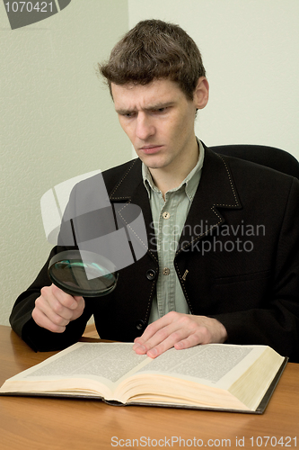 Image of Man read book on a workplace