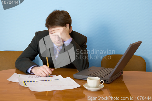 Image of Businessman on a workplace with the laptop