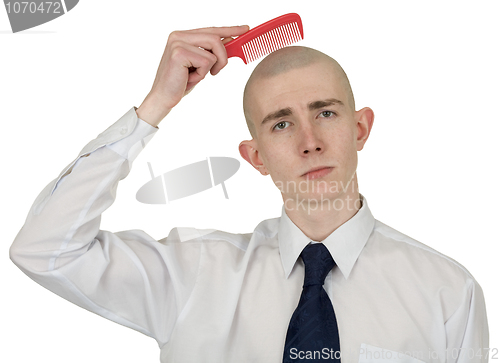 Image of Absolutely bald guy with a hairbrush