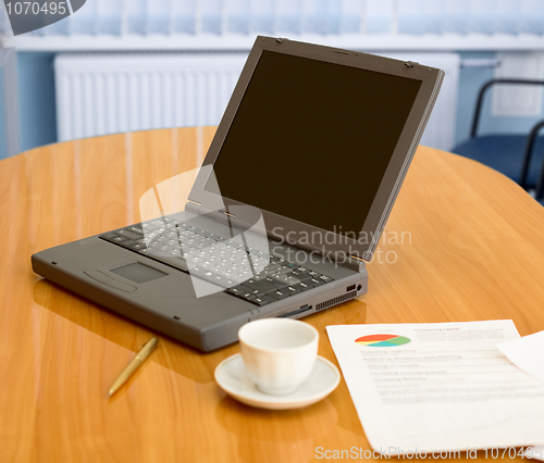 Image of Laptop on a table at office