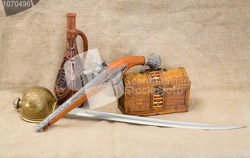 Image of Bottle, rapier, sword, pistol and chest