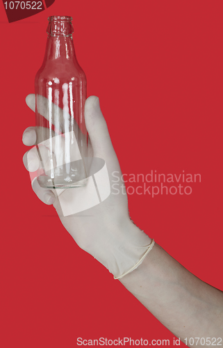 Image of Empty glass bottle on the male hand