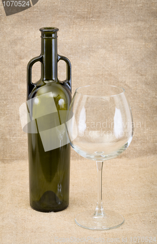 Image of Glass of wine and green bottle