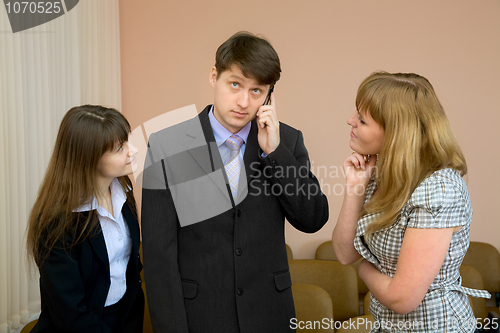 Image of Man speaks by a mobile phone
