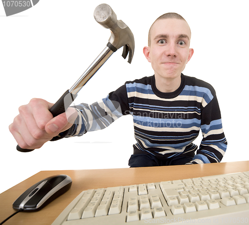 Image of Young man with hammer on hand and keyboard