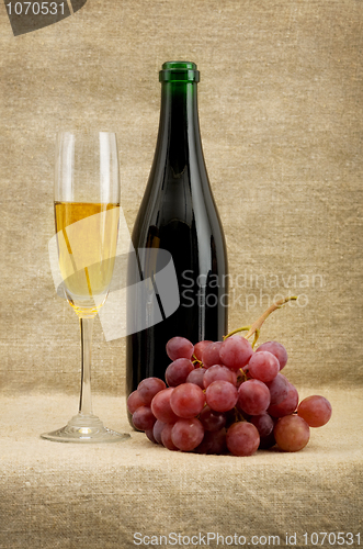 Image of Champagne bottle, goblet, grapes