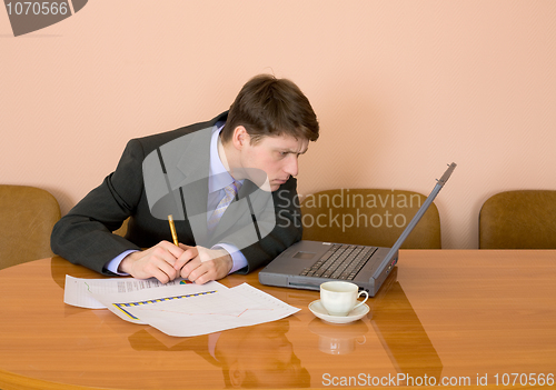 Image of Businessman on a workplace with the laptop