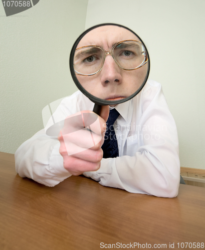 Image of Man with a magnifier in a hand