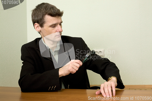 Image of Person view a watch through a magnifier