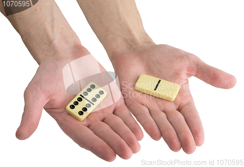 Image of Bones of dominoes on male hands