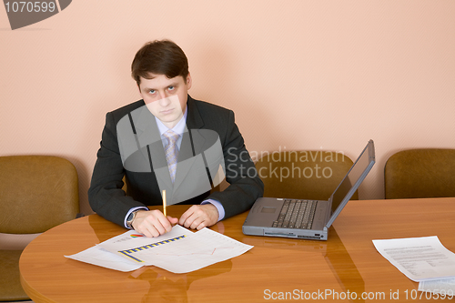 Image of Businessman at a table with laptop